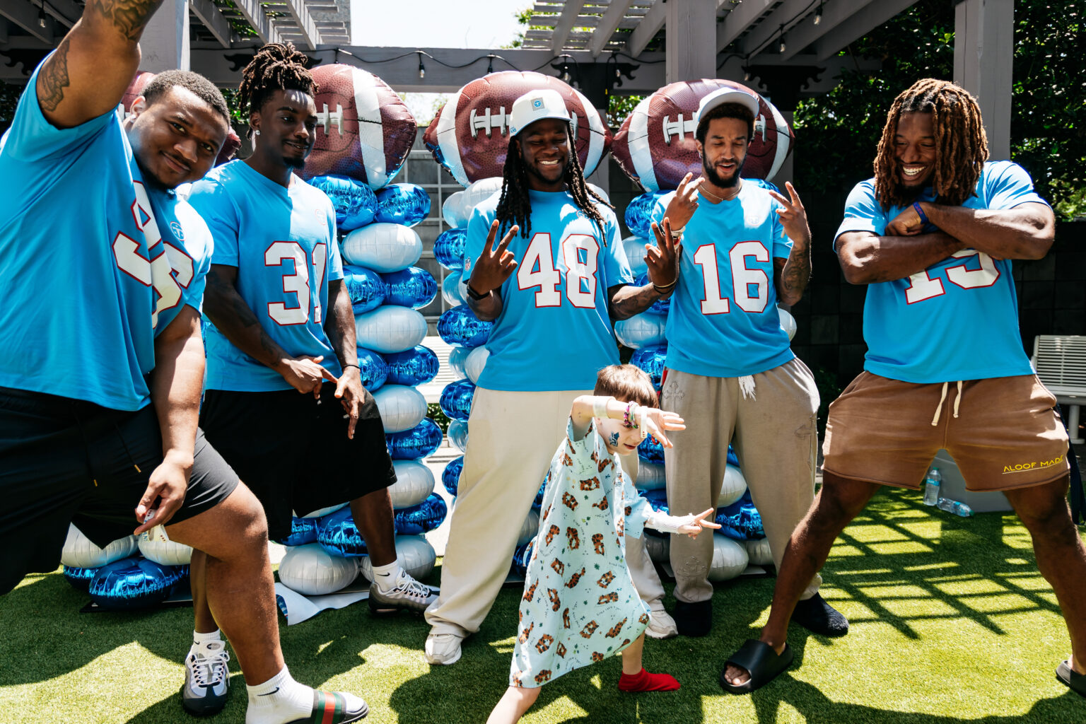 Patient Isaiah Stricklin had fun striking a pose with Tennessee Titans rookies (from left) Jackie Marshall, Bishop Fitzgerald, Sean Brown, Jalen McMurray and Tyren Montgomery during a visit to Monroe Carell Jr. Children’s Hospital at Vanderbilt. (photo by Jessie Rogers/Tennessee Titans)