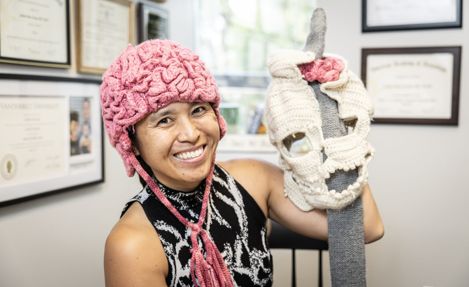 Acosta poses with her hat representing the skull of Phineas Gage, a railroad worker from 19th century Vermont who famously survived being impaled by a steel rod that went directly through his brain. (photo by Erin O. Smith)