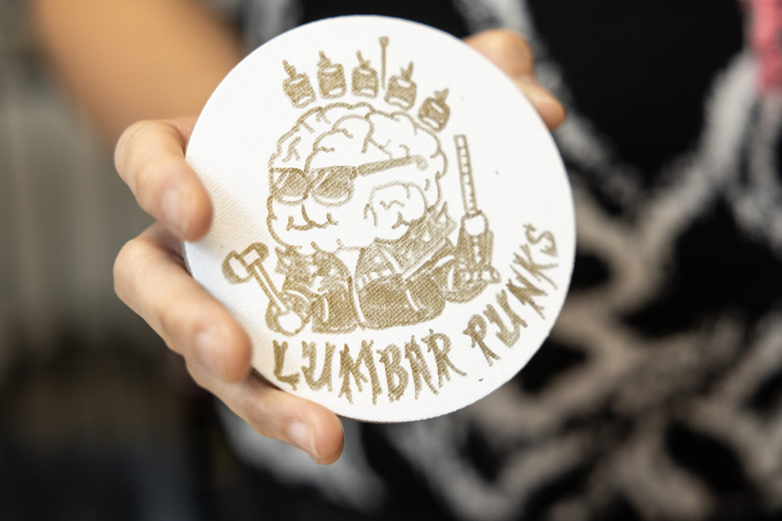 Acosta holds up her hand-drawn logo for a competition team called the 