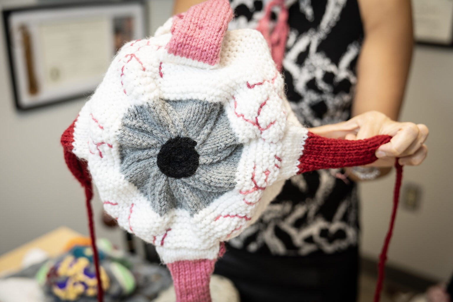Acosta displays her eyeball hat. (photo by Erin O. Smith)