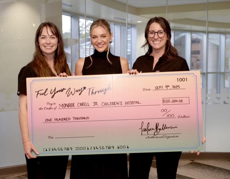 During her visit Kelsea Ballerini presented a check to Heather Kreth, PsyD, left, and Kelsey Gastineau, MD, MPH. (photo by Donn Jones)
