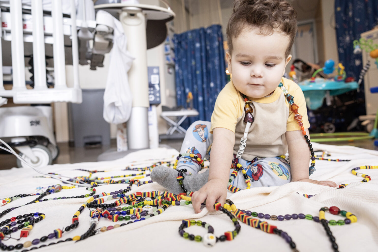 Monroe Carell Jr. Children's Hospital at Vanderbilt patient Nolan Queener plays with his beads of courage. (photo by Erin O. Smith)