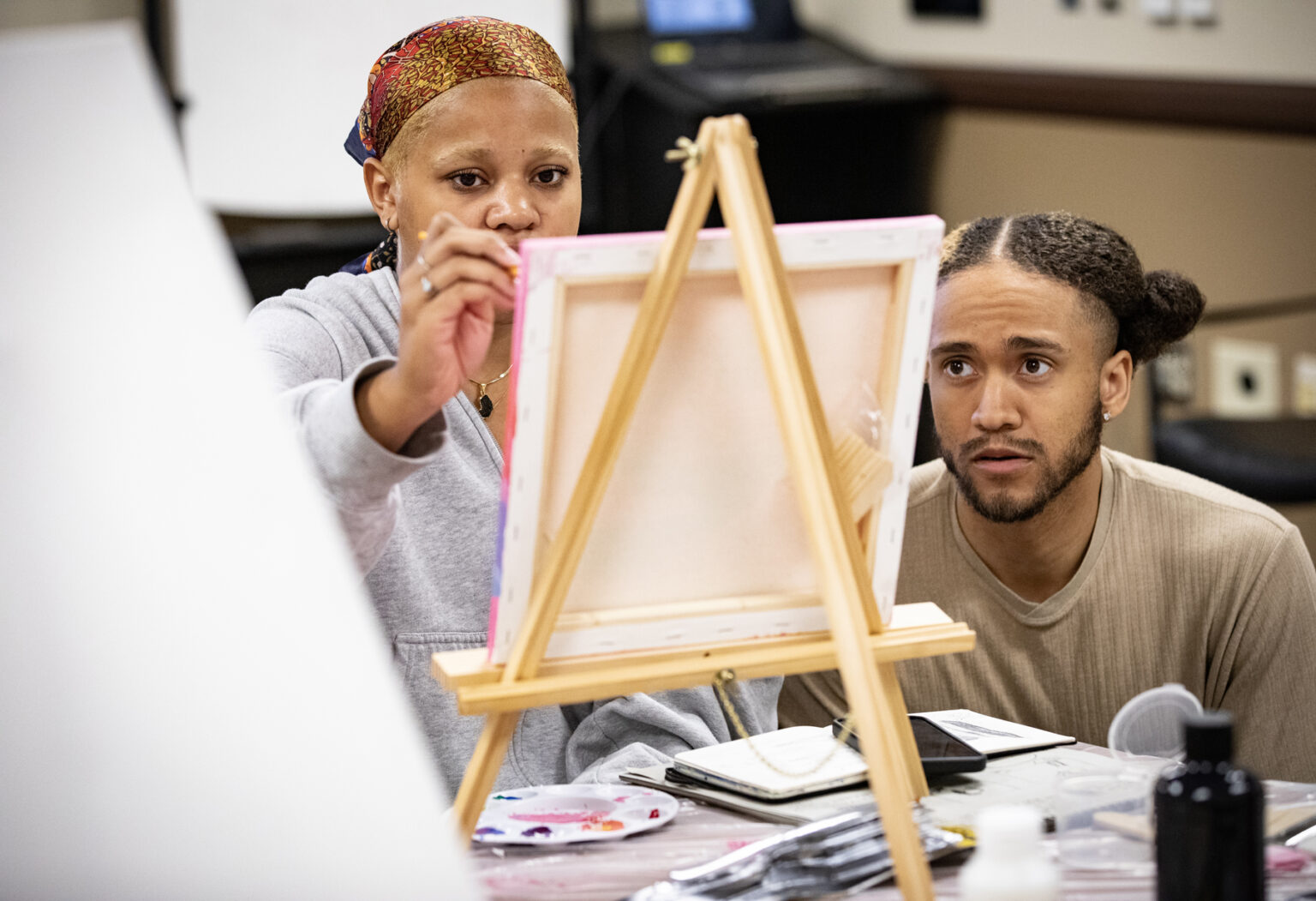 Roz Baxter and Marcus Moore, patients, talk about their artwork during the workshop. (photo by Erin O. Smith)