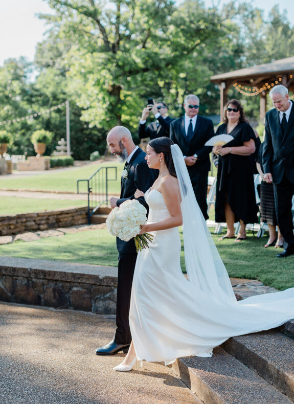 Jason Colee walks his daughter, Emma, down the aisle on her wedding day. Moments like this one were top of mind for Jason and his wife, Jennifer, as they weighed the risks of spinal surgery.