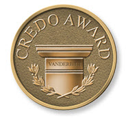 Bronze circular medallion embossed with “CREDO AWARD,” featuring a central column, laurel branches, and a small plaque reading “VANDERBILT.”
