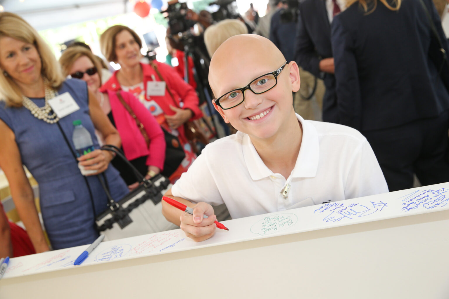 Patient ambassador Dalton Waggoner signs the construction beam at the 2015 Growing to New Heights celebration of the expansion at Monroe Carell Jr. Children’s Hospital at Vanderbilt. (photo by Joe Howell)