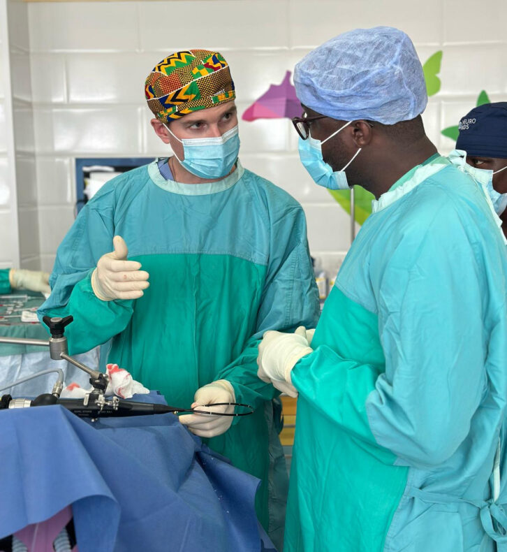 Michael Dewan, MD, assistant professor of Neurological Surgery, discusses a case with a fellow surgeon in Monrovia, Liberia.