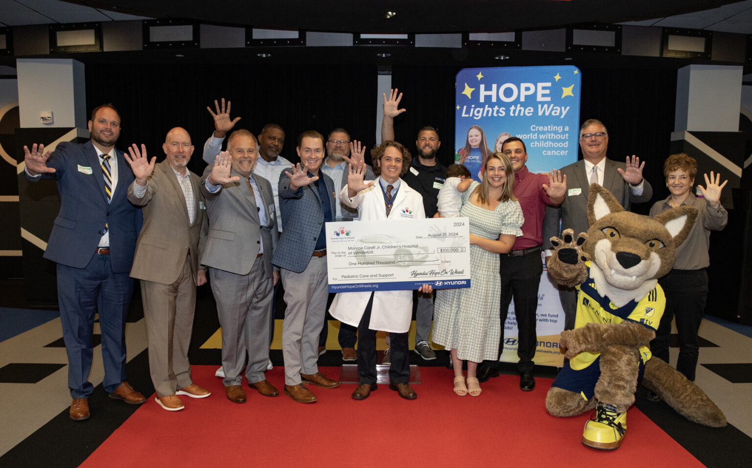 Representatives from Hyundai Hope on Wheels, VUMC, patient families and Nashville FC mascot Tempo pose for a group photo during the Hyundai Hope on Wheels check presentation. (photo by Erin O. Smith)