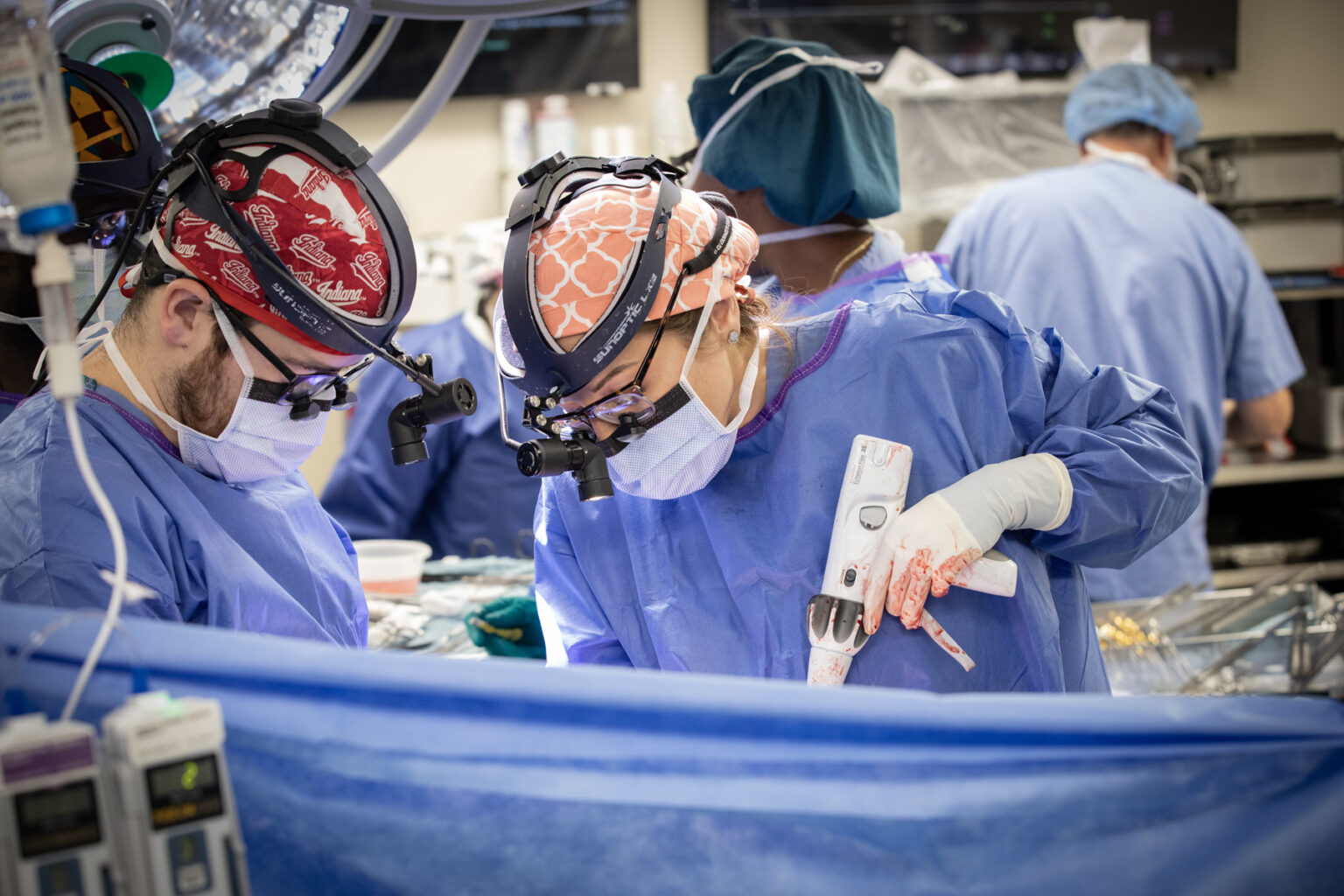 Brandon Petree, MD, and Caitlin Demarest, MD, PhD, operate on a patient during a recent double lung transplant. (photo by Erin O. Smith)