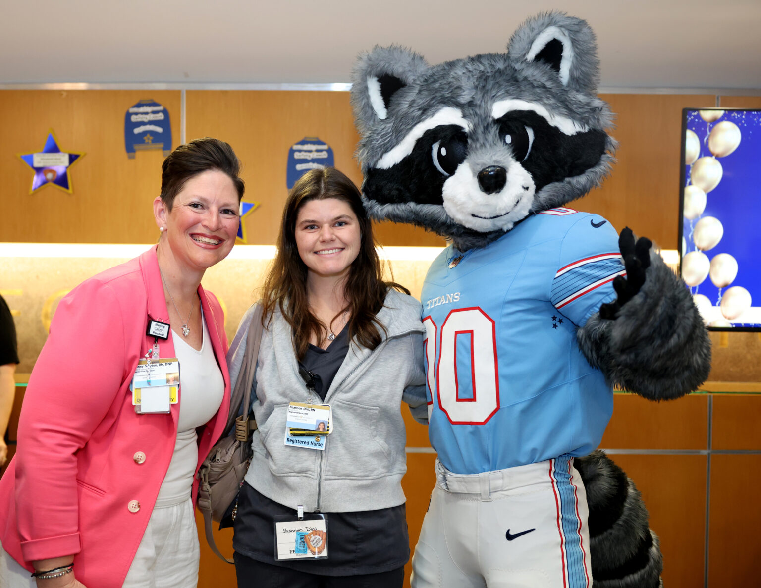 Jenny Slayton, RN, DNP, left, Shannon Dial, RN, and Tennessee Titans mascot T-Rac pose for a photo after a raffle drawing at the Making Safety Personal Celebration. (photo by Donn Jones)