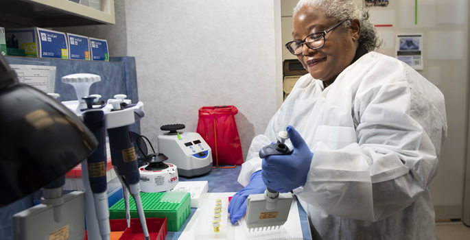 Medical laboratory scientist Gladys Garrison, MT, MS, loads reagents to prepare DNA samples for analysis in the VUMC Molecular Diagnostics Lab.