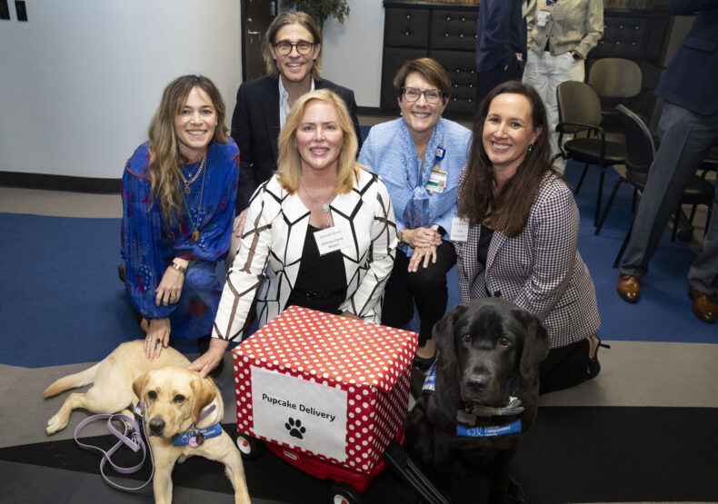 From left, Shelly Colvin, Jeff Colvin, Kathryn Carell Brown (front), Dr. Meg Rush, and Larisa Featherstone join Velour and Squid, Monroe Carell’s Canine Clinicians, to celebrate the fundraising success of the pediatric rehabilitation campaign. (photo by Susan Urmy)