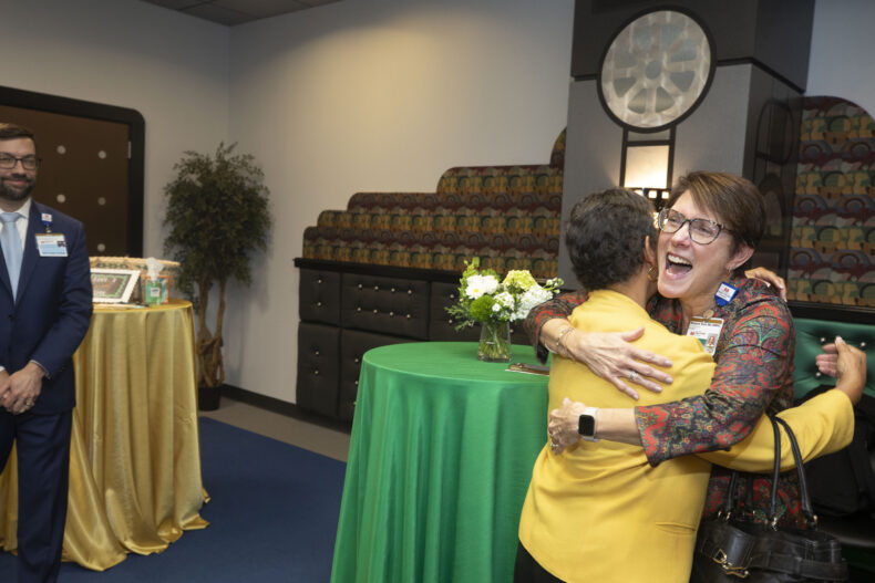 Hugs were abundant at the reception honoring Meg Rush, MD, MMHC. (photo by Susan Urmy)