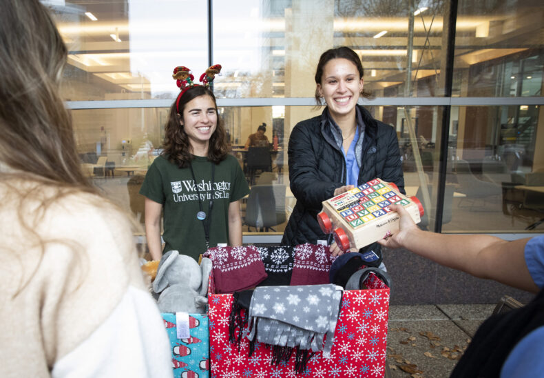 VUMC lends its institutional support to Shade Tree Clinic in many ways. Here, medical students Anna Hinricks and Kayla Buttafuoco collect food, toys and warm clothing for the clinic’s patients. (photo by Susan Urmy)