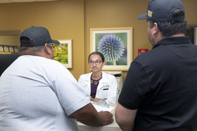 Rohini (Ro) Chakravarthy, MD, MBA, talks to patients at Shade Tree Clinic. Chakravarthy worked at the clinic as a Vanderbilt medical student, and one of the first things she wanted to do when she returned as faculty was to begin volunteering again, this time as a faculty medical director. (photo by Susan Urmy)