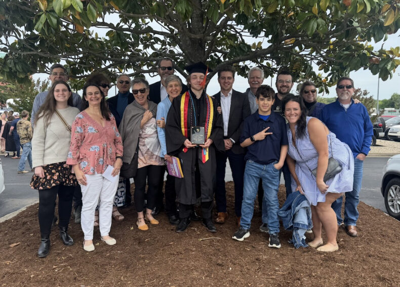 Surrounded by those who stood by him, Sean Smith celebrates his graduation from Murray State University just six months into his recovery from burns caused by a kitchen fire.