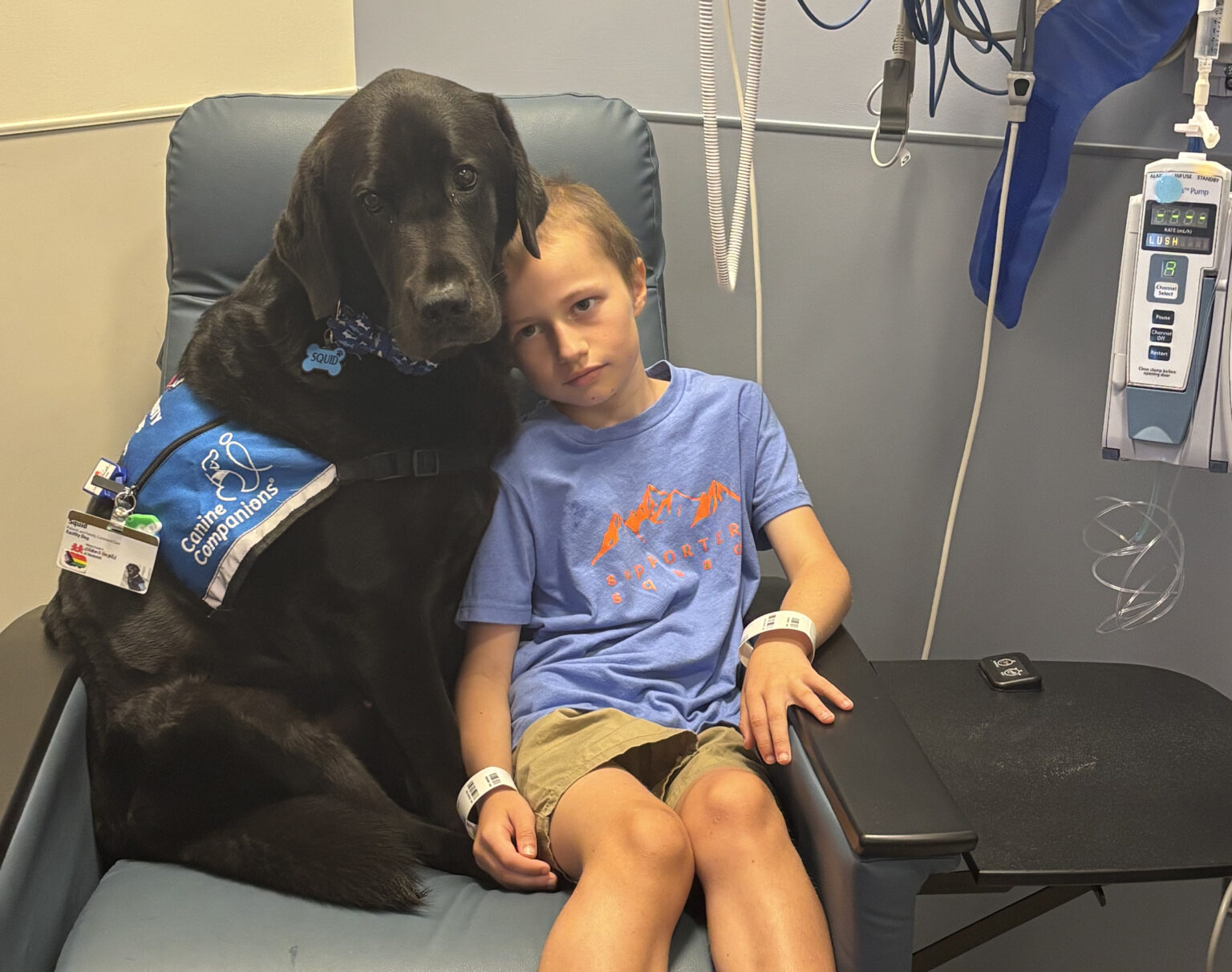 Patient Porter Pickett with facility dog Squid.