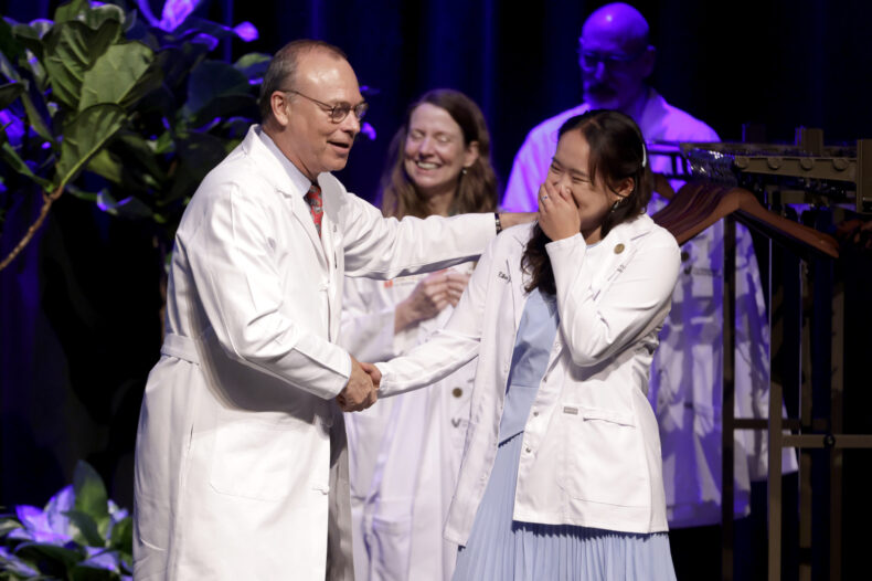 Eileen Yu of Fort Worth, Texas, smiles as she’s being congratulated by Jeff Balser, MD, PhD. (photo by Donn Jones)