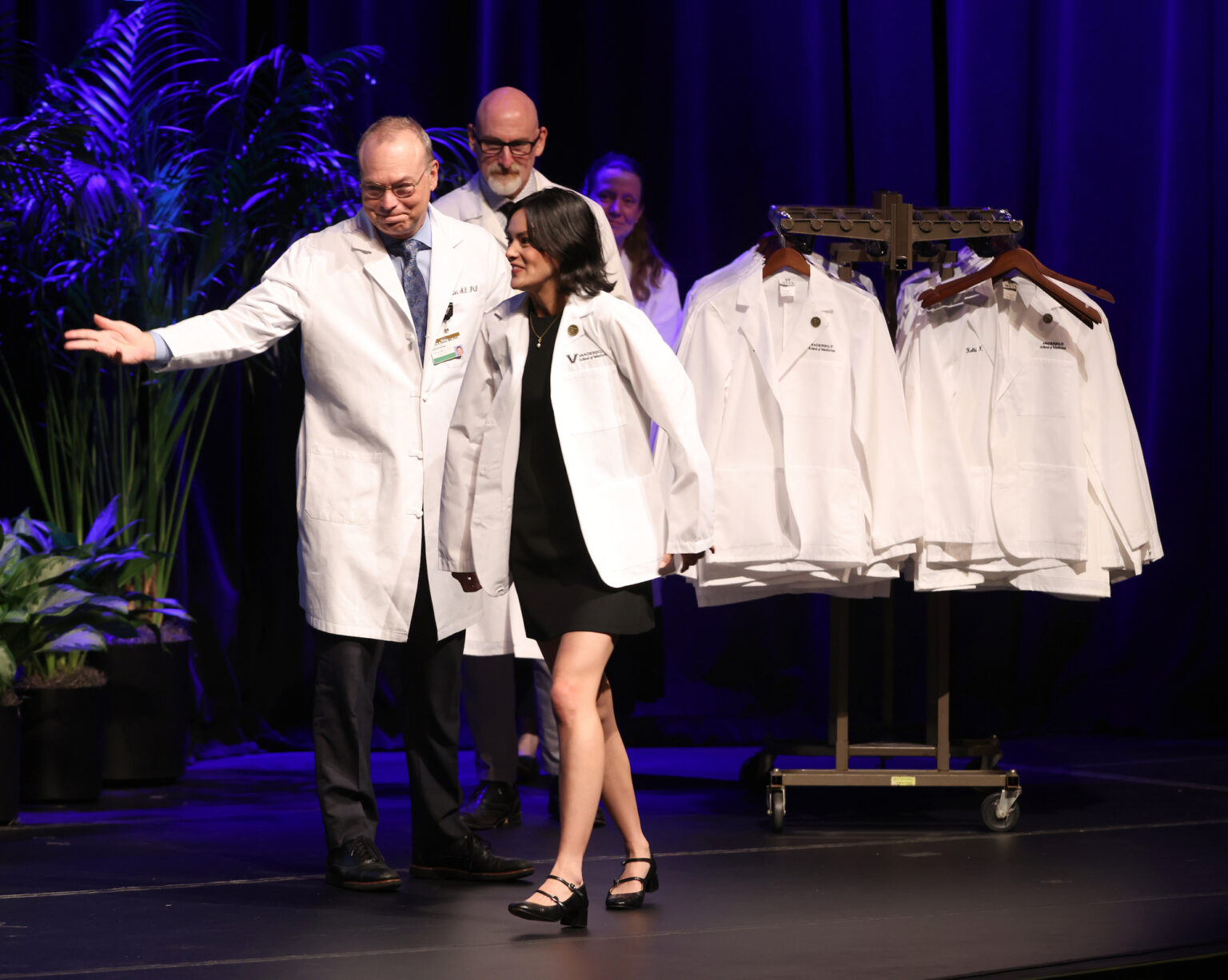 After she receives her white coat, Jeff Balser, MD, PhD, directs Elena Inthavanh Amonette, a Belmont University graduate, to the stage exit.
