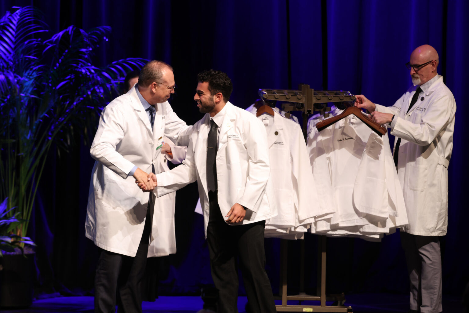 Jeff Balser, MD, PhD, shakes hands with Youssef Mohamed Saad, a graduate of Washington University in St. Louis.