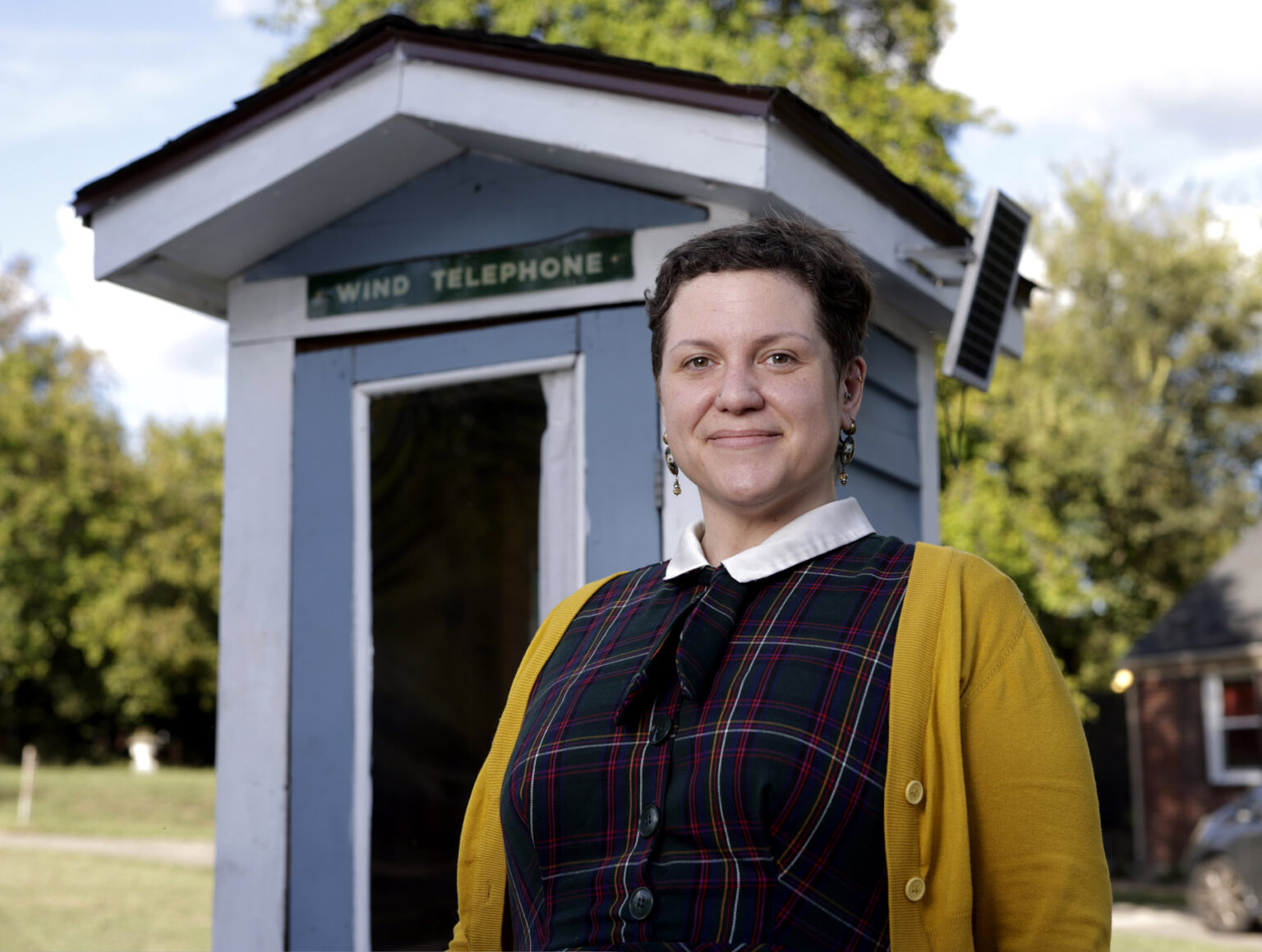 Vanderbilt nurse Allison Young, MS, BSN, RN, outside the “wind phone” booth at her home. (photo by Donn Jones)