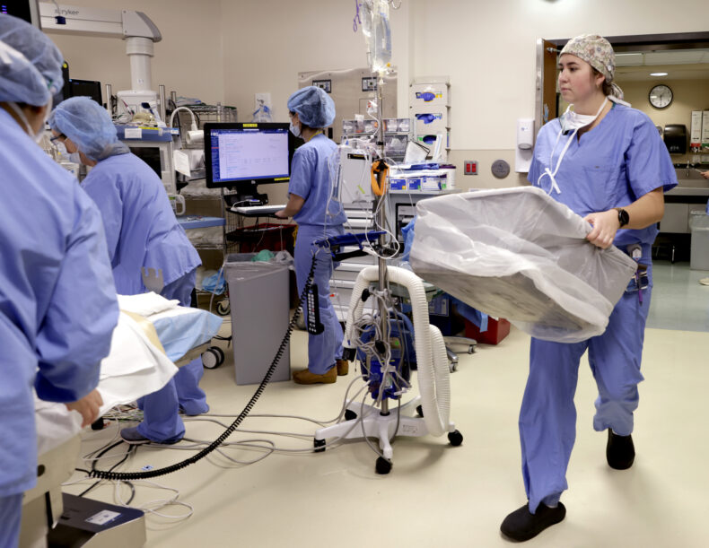 Surgical technologist Nicole Luebs, CST,readies the operating room with the tub needed for histotripsy. (photo by Donn Jones)