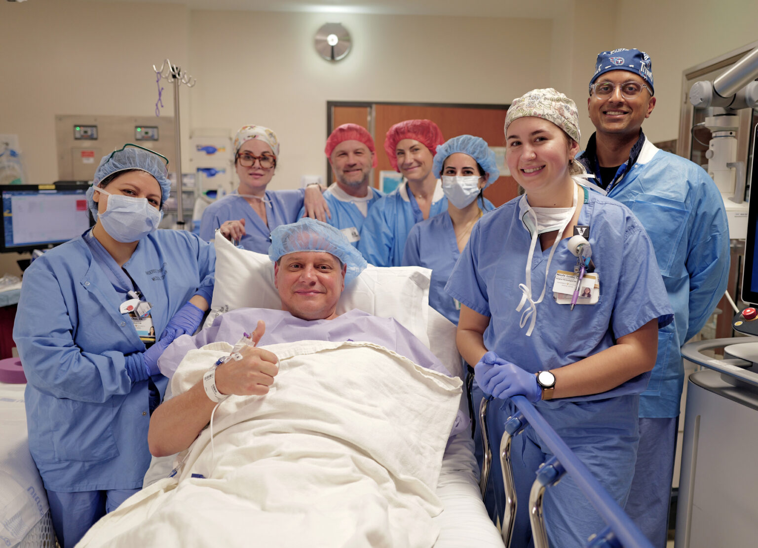 Before being sedated, Aaron Davis gives a thumbs up with his surgical team. (photo by Donn Jones)