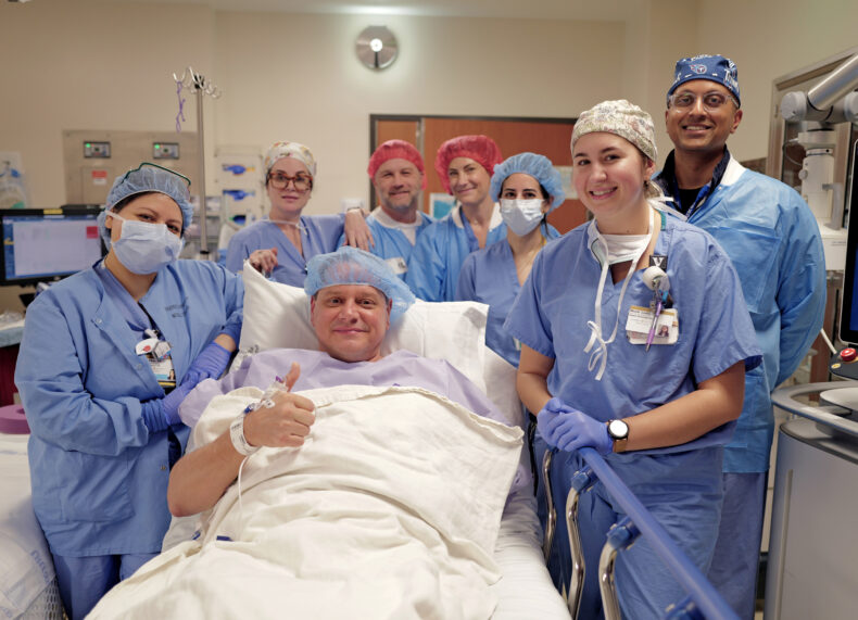 Before being sedated, Aaron Davis gives a thumbs up with his surgical team. (photo by Donn Jones)