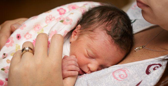premature baby sleeping on mom's chest