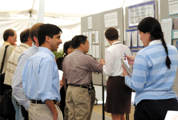 Maria Person, Ph.D., from the University of Texas at Austin, talks with Ashutosh Mishra of St. Jude Children's Hospital during a poster session at the Proteomics Conference last week. (photo by Dana Johnson)