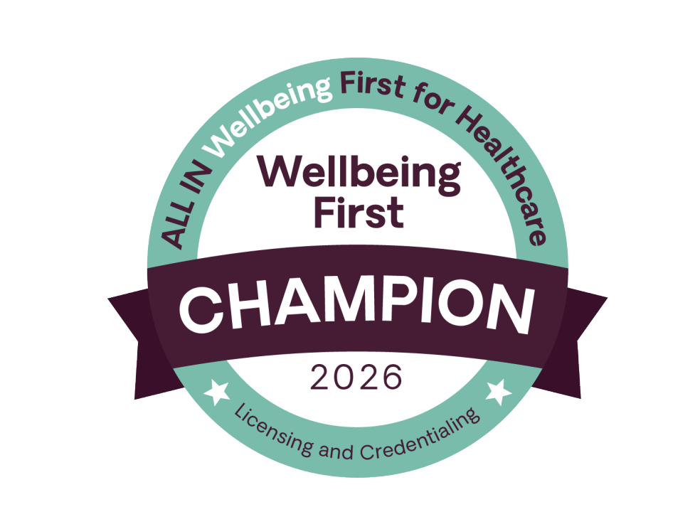 Circular teal and dark purple badge reading “ALL IN Wellbeing First for Healthcare,” “Wellbeing First,” “CHAMPION,” “2026,” and “Licensing and Credentialing,” with two white stars.